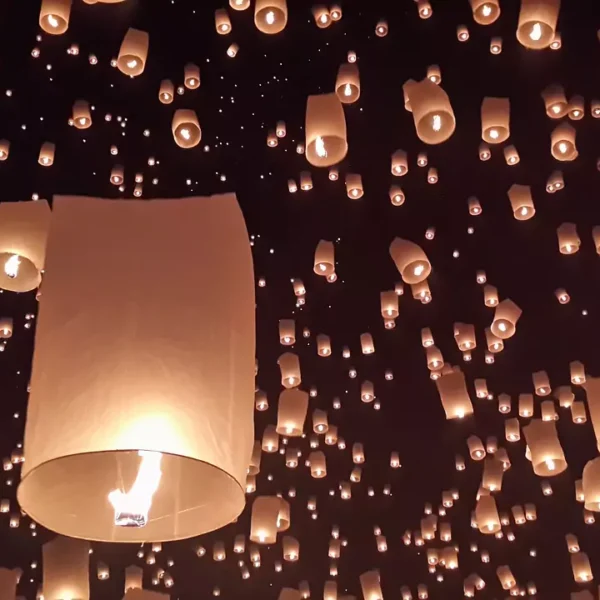 housands of golden sky lanterns (khom loy) ascend into the dark night sky during the Yi Peng festival, creating a breathtaking and magical display of light.