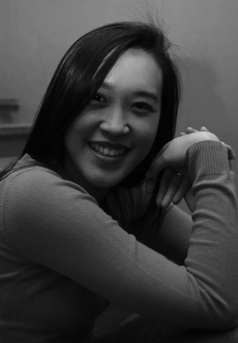 Hataitip, a Chiang Mai native and founder of Thaitop, smiling in a black and white portrait.