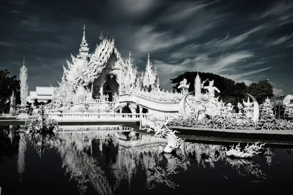 beautiful reflection of white Wat Rong Khun on water. Simple devine