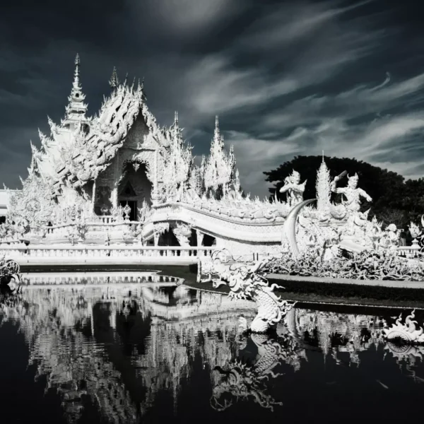beautiful reflection of white Wat Rong Khun on water. Simple devine