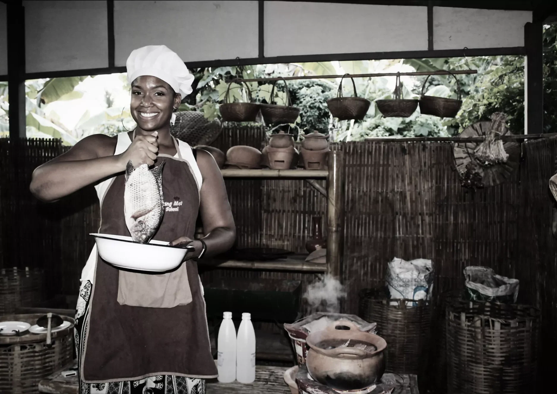 Chef proudly shows fresh fish at traditional Thai kitchen