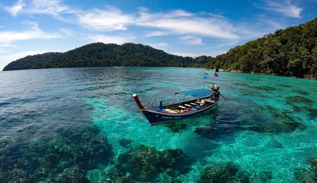 Surin Islands appearing on the horizon — jungle peaks rising from Andaman blue