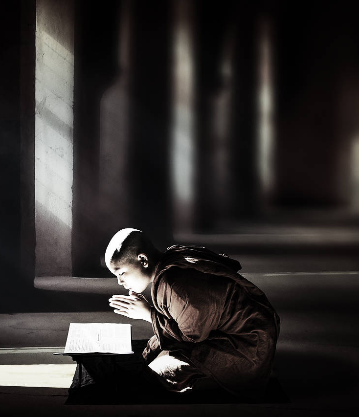 Young Thai monk in Buddhist temple