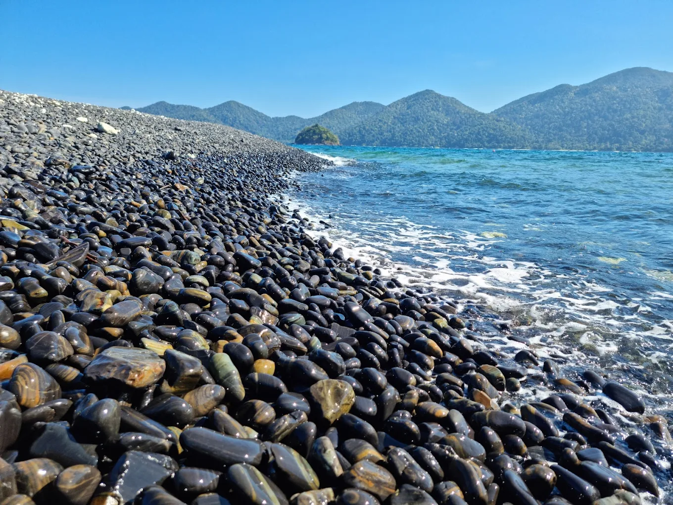 Ko Hin Ngam black pebble beach — ancient limestone fragments, natural patterns