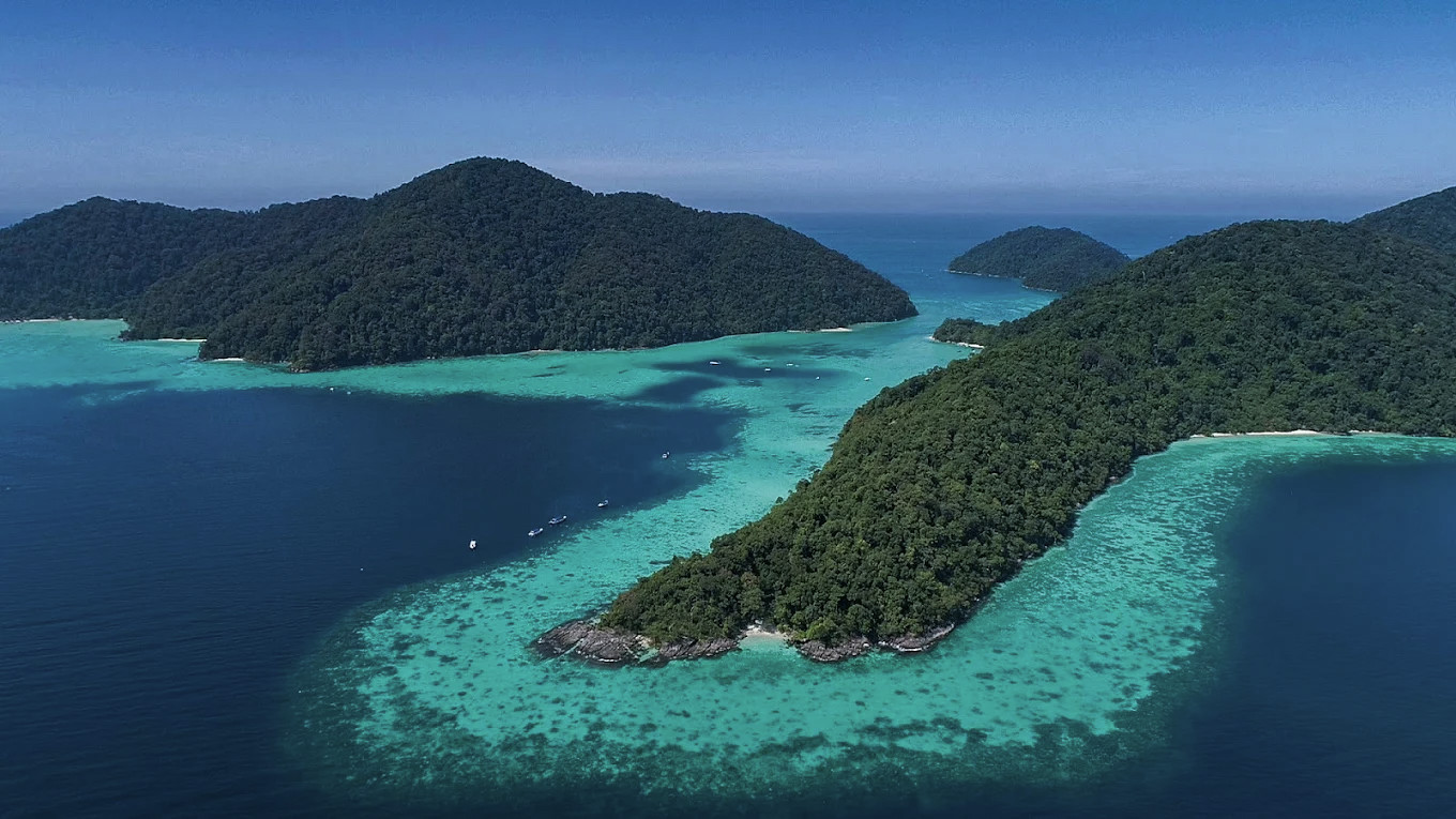 Aerial view of Surin Islands — coral reefs visible through clear Andaman water
